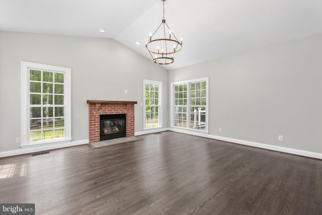 unfurnished living room featuring a chandelier, plenty of natural light, dark wood-style floors, and high vaulted ceiling