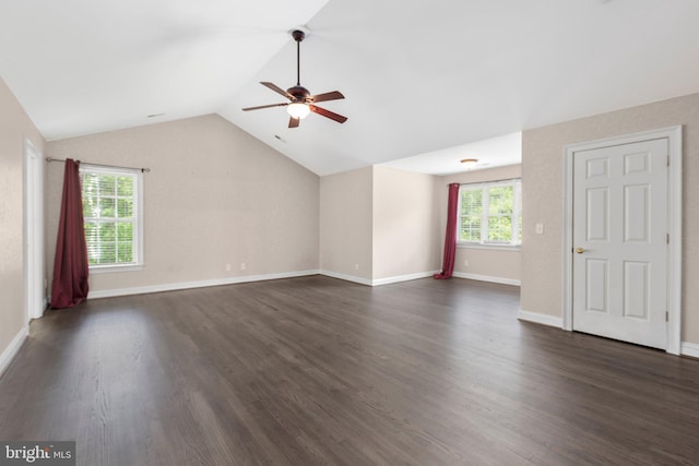 unfurnished living room with ceiling fan, lofted ceiling, dark wood finished floors, and baseboards