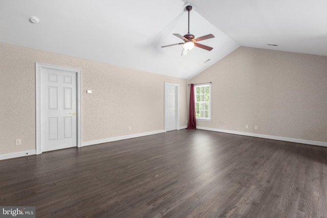 unfurnished living room featuring ceiling fan, vaulted ceiling, dark wood-type flooring, and baseboards