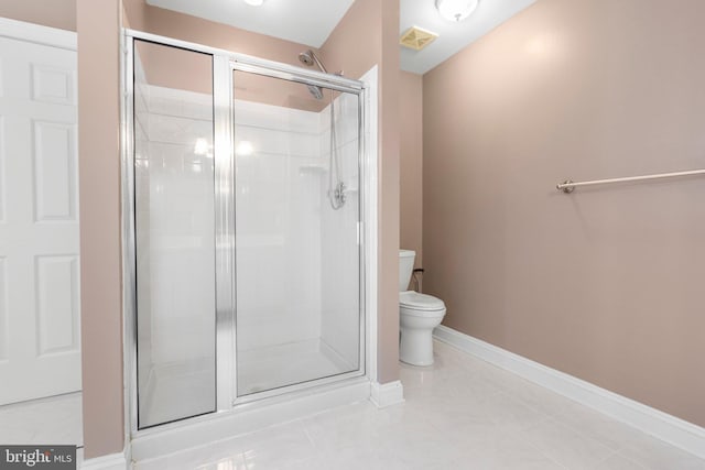 full bath with a stall shower, toilet, tile patterned flooring, and baseboards