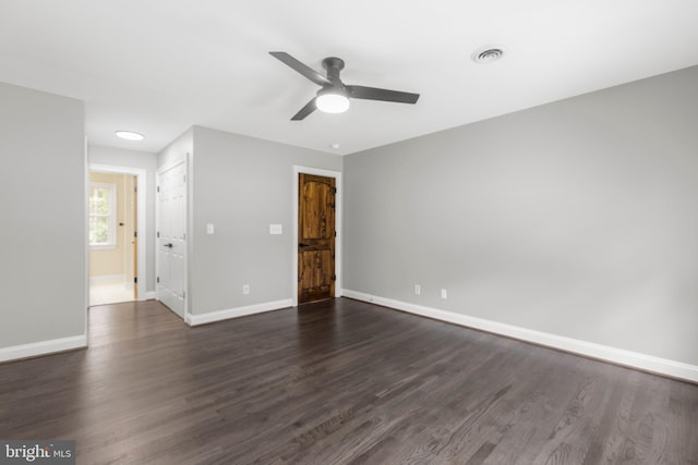 unfurnished bedroom with baseboards, dark wood-type flooring, and a ceiling fan