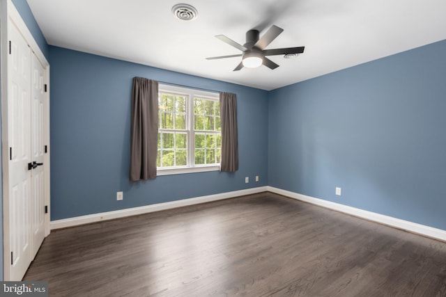 unfurnished room featuring wood finished floors, a ceiling fan, and baseboards