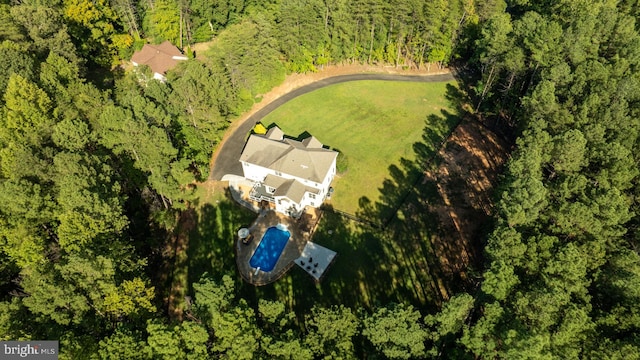view of property location with a heavily wooded area