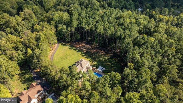 aerial overview of property's location with a heavily wooded area