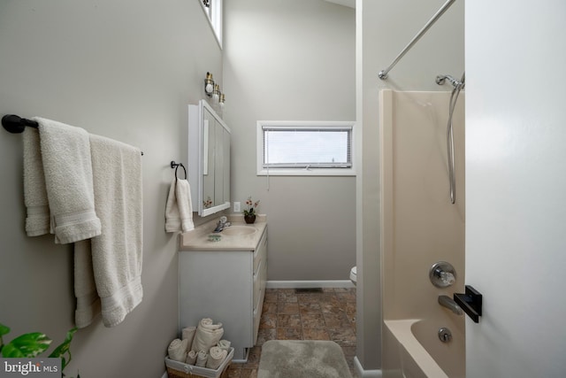 1105 N Bay Shore Dr, Milton, DE 19968 - full bath featuring vanity, stone finish floors, shower / bath combination, baseboards, and toilet