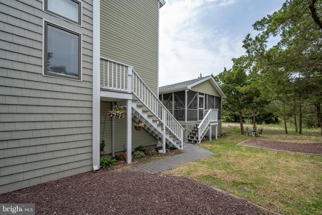 1105 N Bay Shore Dr, Milton, DE 19968 - view of property exterior featuring stairway, a sunroom, and a lawn