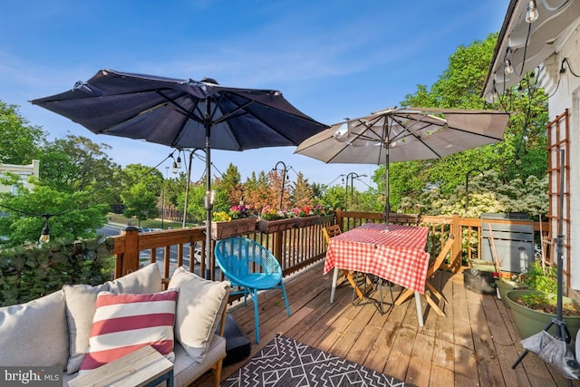 wooden terrace with outdoor dining area