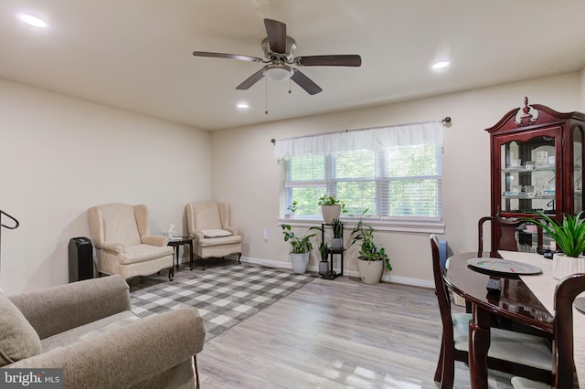 living room featuring a ceiling fan, baseboards, recessed lighting, and light wood-type flooring