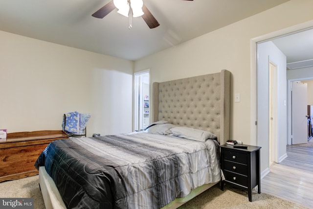 bedroom featuring baseboards, a ceiling fan, and wood finished floors