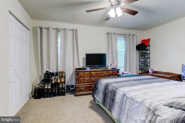 bedroom featuring a closet, ceiling fan, and carpet flooring