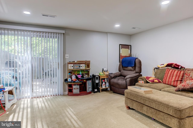 living area with plenty of natural light, carpet, and visible vents
