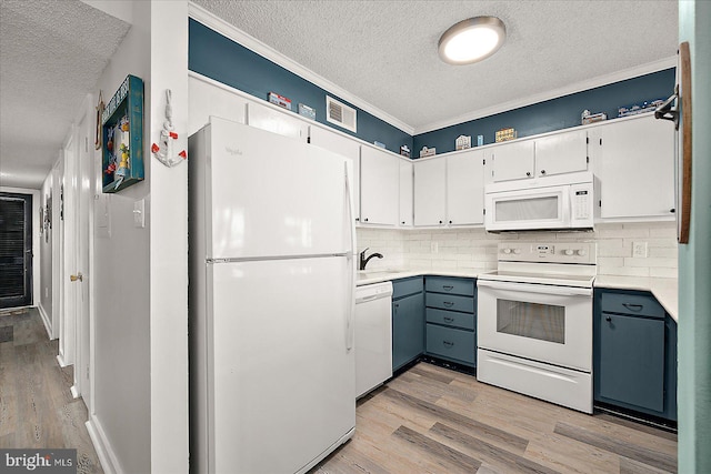 119 Old Landing Rd Unit 205A, Ocean City, MD 21842 - kitchen with white appliances, a textured ceiling, light wood finished floors, decorative backsplash, and light countertops