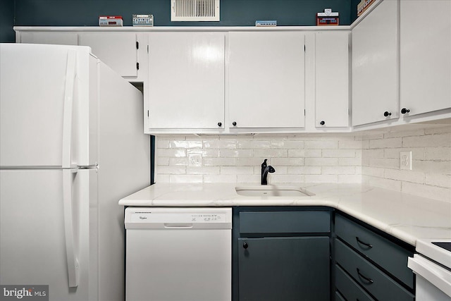 119 Old Landing Rd Unit 205A, Ocean City, MD 21842 - kitchen with white cabinets, decorative backsplash, a sink, and white appliances