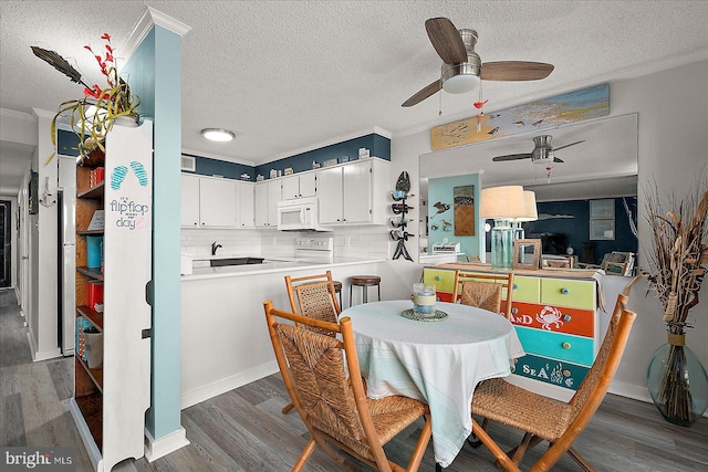 119 Old Landing Rd Unit 205A, Ocean City, MD 21842 - dining space with crown molding, a textured ceiling, a ceiling fan, and dark wood finished floors