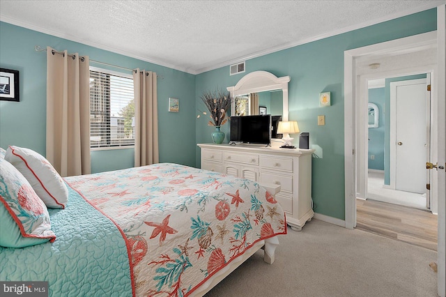 119 Old Landing Rd Unit 205A, Ocean City, MD 21842 - bedroom featuring ornamental molding, a textured ceiling, visible vents, light carpet, and baseboards