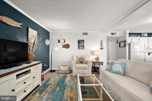 119 Old Landing Rd Unit 205A, Ocean City, MD 21842 - living area featuring a textured ceiling, wood finished floors, ornamental molding, and baseboards