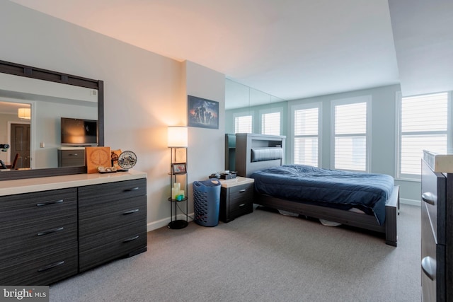 bedroom with carpet floors and baseboards