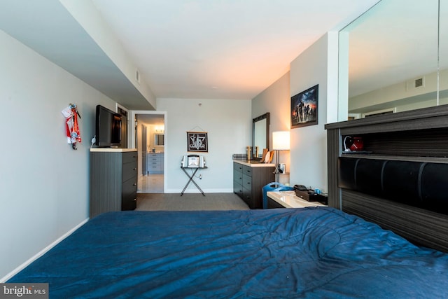 bedroom with visible vents, baseboards, and dark carpet