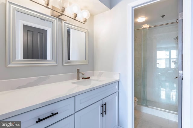 full bath featuring vanity, tile patterned floors, a stall shower, and toilet