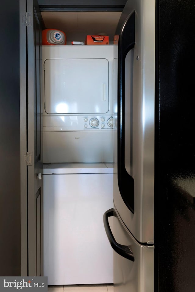 washroom with laundry area and stacked washer and dryer