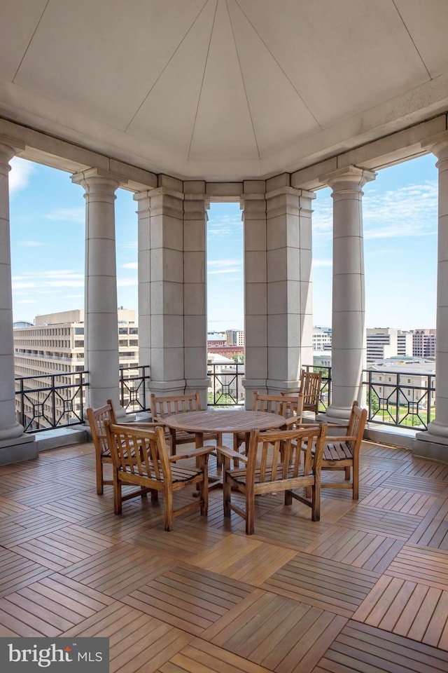 dining space with ornate columns and a wall of windows