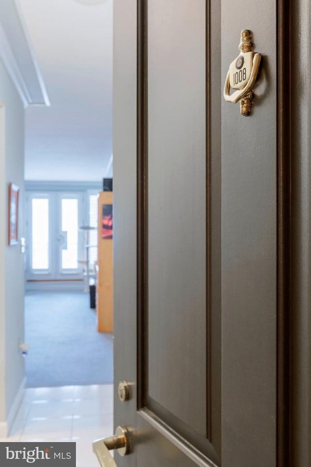 hall featuring carpet and attic access