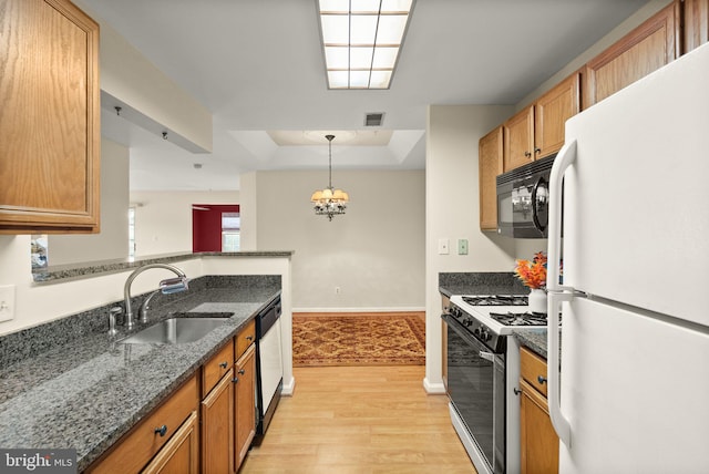 8075 Lacy Dr Unit 303, Manassas, VA 20109 - kitchen with a sink, white appliances, brown cabinets, light wood-type flooring, and a raised ceiling