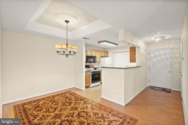 8075 Lacy Dr Unit 303, Manassas, VA 20109 - kitchen with light wood-style flooring, white appliances, a peninsula, a chandelier, and dark countertops