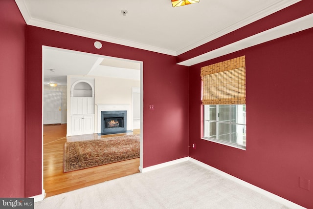 8075 Lacy Dr Unit 303, Manassas, VA 20109 - unfurnished living room featuring crown molding, baseboards, a fireplace with flush hearth, and carpet floors