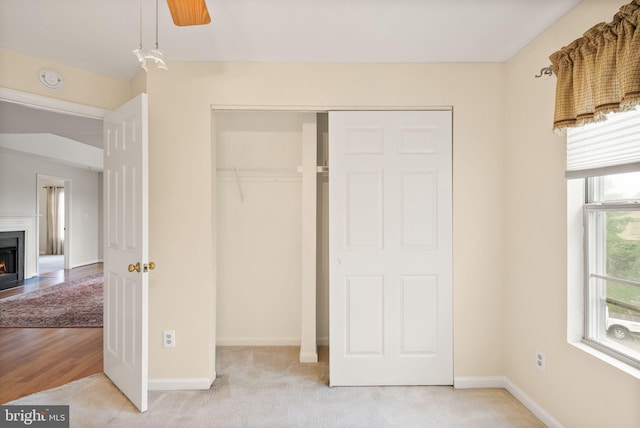 8075 Lacy Dr Unit 303, Manassas, VA 20109 - unfurnished bedroom featuring carpet floors, a closet, a fireplace with flush hearth, and baseboards