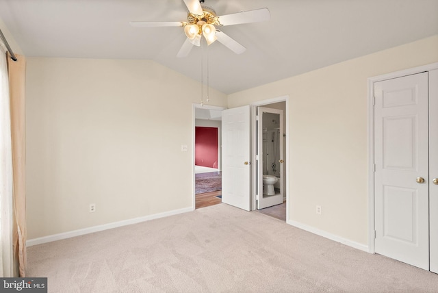8075 Lacy Dr Unit 303, Manassas, VA 20109 - unfurnished bedroom featuring baseboards, ensuite bath, ceiling fan, vaulted ceiling, and carpet floors