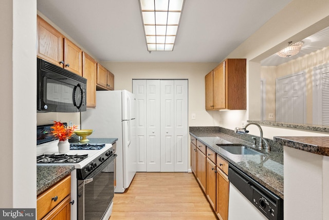 8075 Lacy Dr Unit 303, Manassas, VA 20109 - kitchen featuring a sink, dishwasher, light wood finished floors, black microwave, and gas range