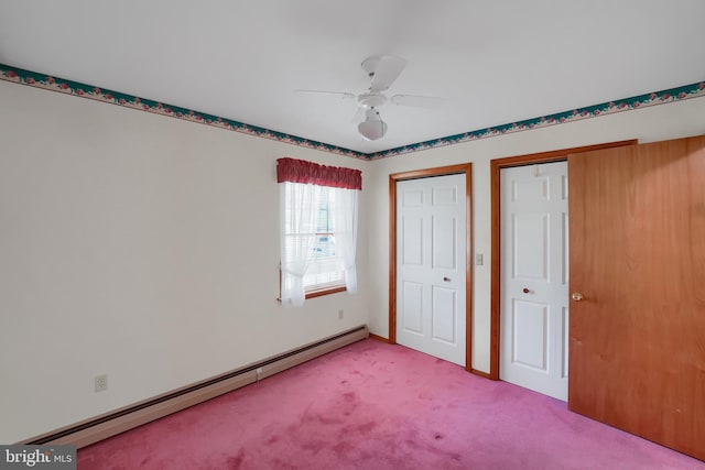 unfurnished bedroom with light colored carpet, multiple closets, ceiling fan, and baseboard heating