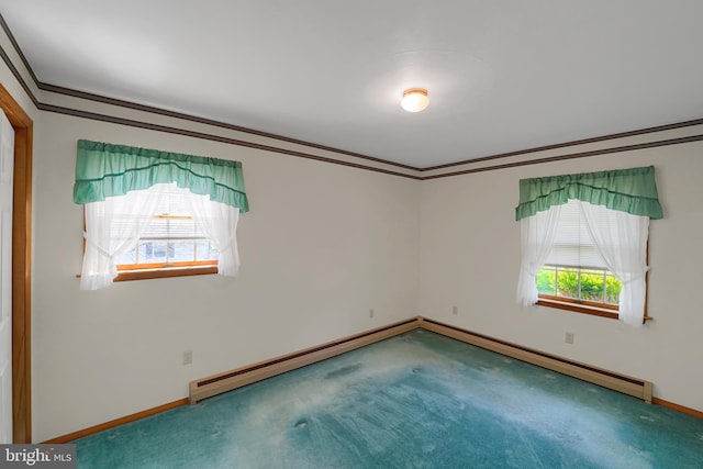carpeted spare room featuring baseboards, ornamental molding, and baseboard heating
