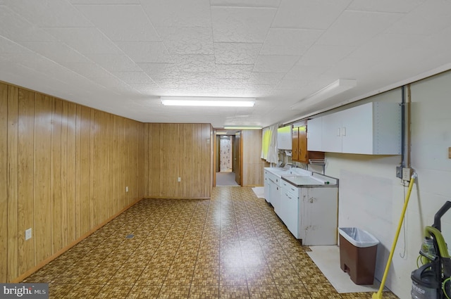finished basement with wood walls and light floors