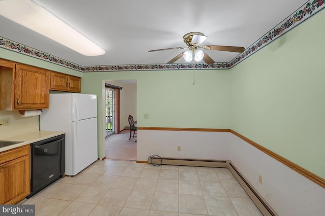 kitchen with a ceiling fan, baseboard heating, brown cabinets, freestanding refrigerator, and black dishwasher