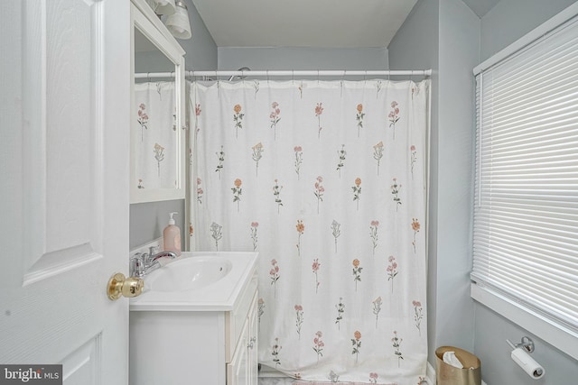 bathroom with vanity, plenty of natural light, and curtained shower