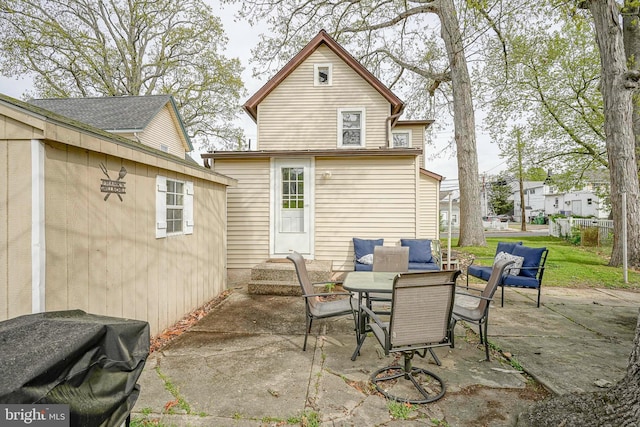 back of house featuring a patio and an outdoor hangout area