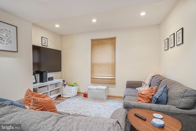 living room with recessed lighting, baseboards, and wood finished floors