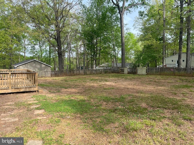 view of yard with a deck and a fenced backyard