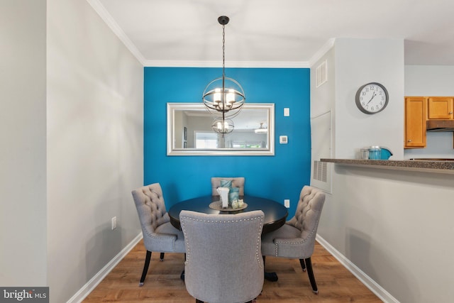 13347 Connor Dr Unit H, Centreville, VA 20120 - dining area with wood finished floors, a chandelier, baseboards, and ornamental molding