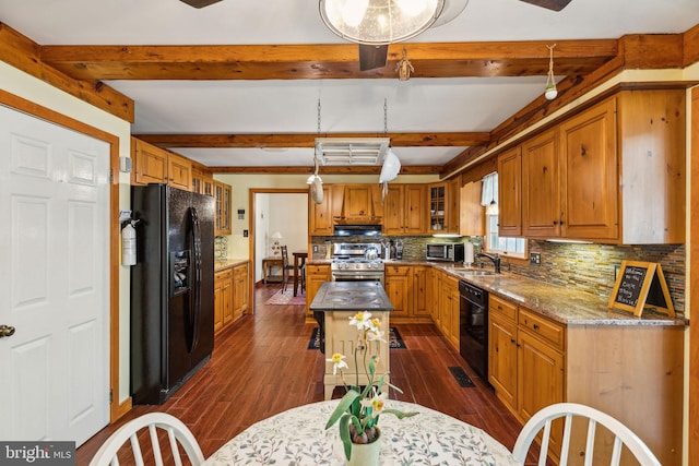 kitchen with decorative backsplash, beamed ceiling, a center island, black appliances, and brown cabinetry