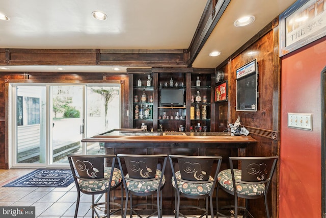 bar with recessed lighting, a bar, and tile patterned flooring