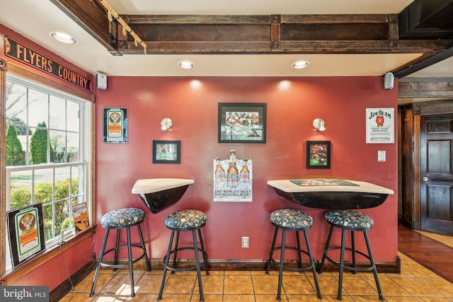 bar with recessed lighting, tile patterned floors, and baseboards