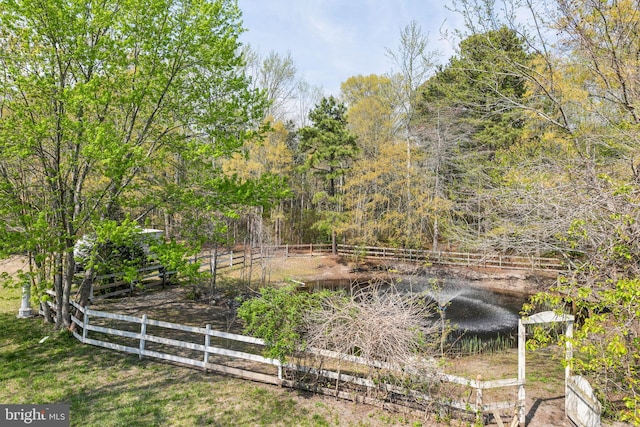 view of yard featuring a water view and fence