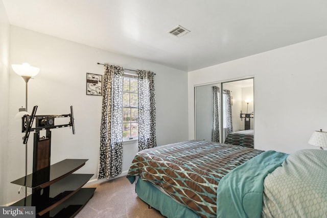 bedroom featuring a closet, visible vents, carpet floors, and baseboards