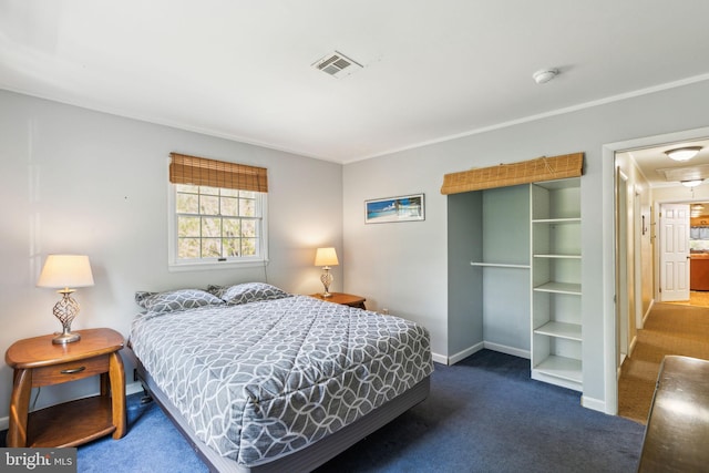 bedroom with carpet floors, attic access, ornamental molding, baseboards, and visible vents