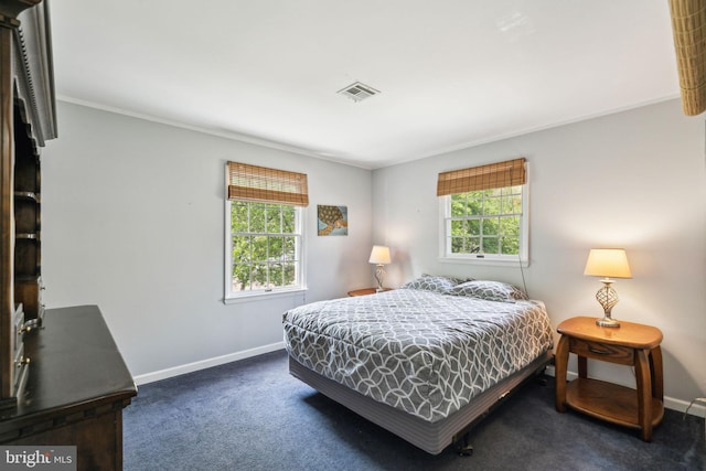 bedroom featuring baseboards, visible vents, crown molding, and carpet flooring