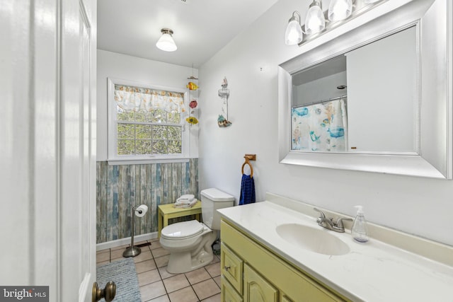 bathroom featuring toilet, tile patterned flooring, and vanity