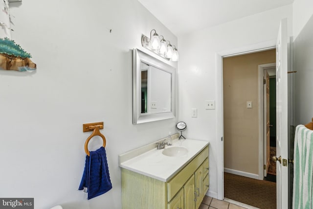 bathroom featuring baseboards, tile patterned flooring, and vanity